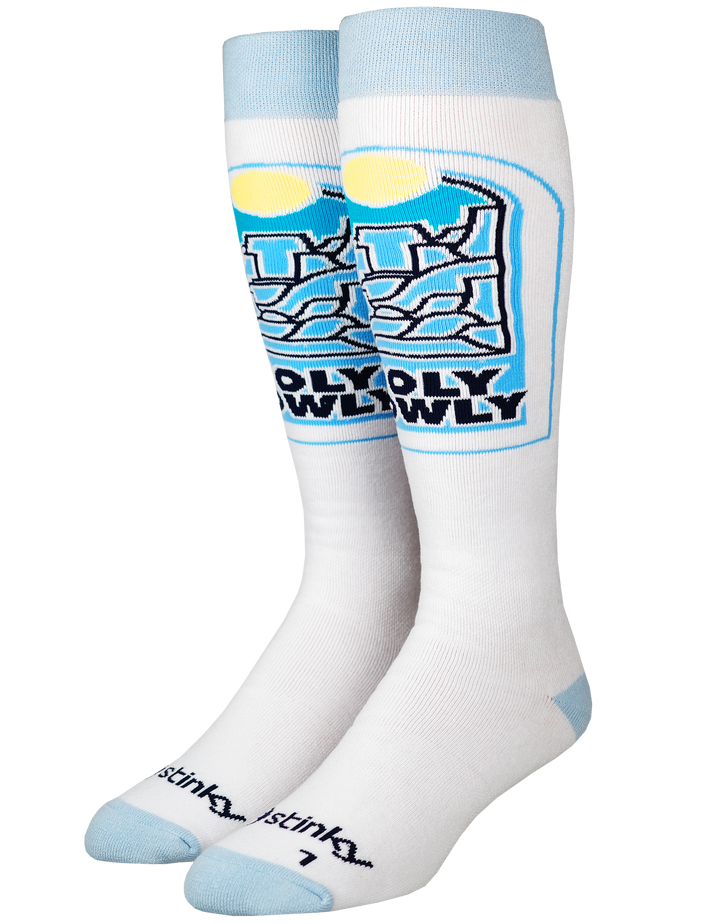 A pair of white crew socks with light blue cuffs, heels, and toes, featuring a large graphic on the front leg with the text 'OLYOLY OWLY' in black and blue, and the brand name 'istinky' printed near the toes.