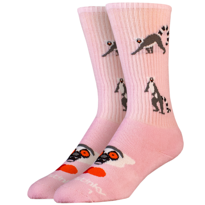 Pink socks with lemur designs on a white background