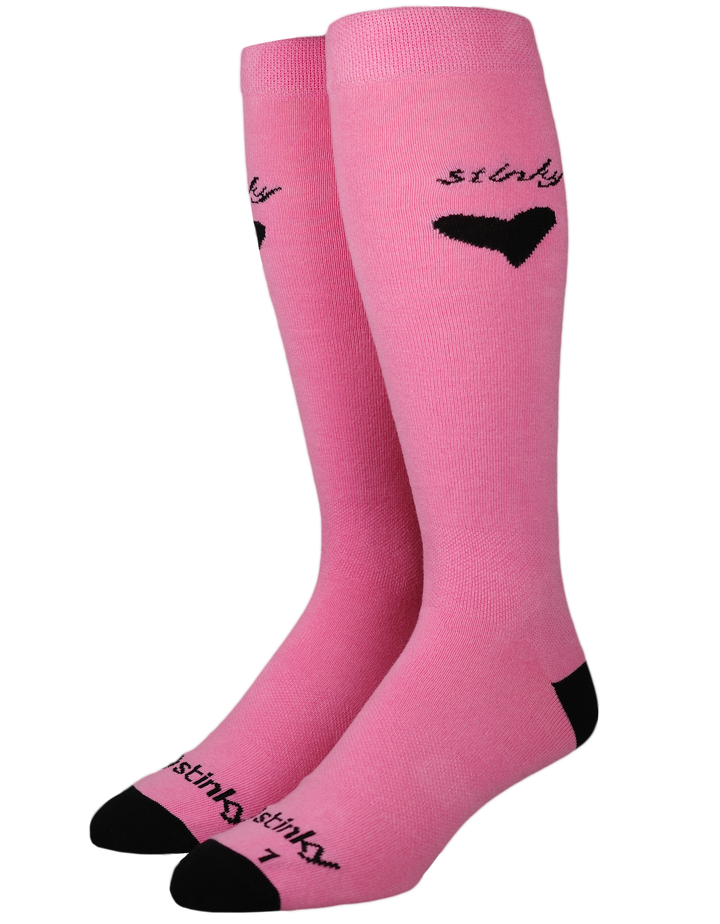 A pair of pink knee-high socks with black heels, toes, and heels, featuring the word 'stinky' and a heart graphic on the upper leg.
