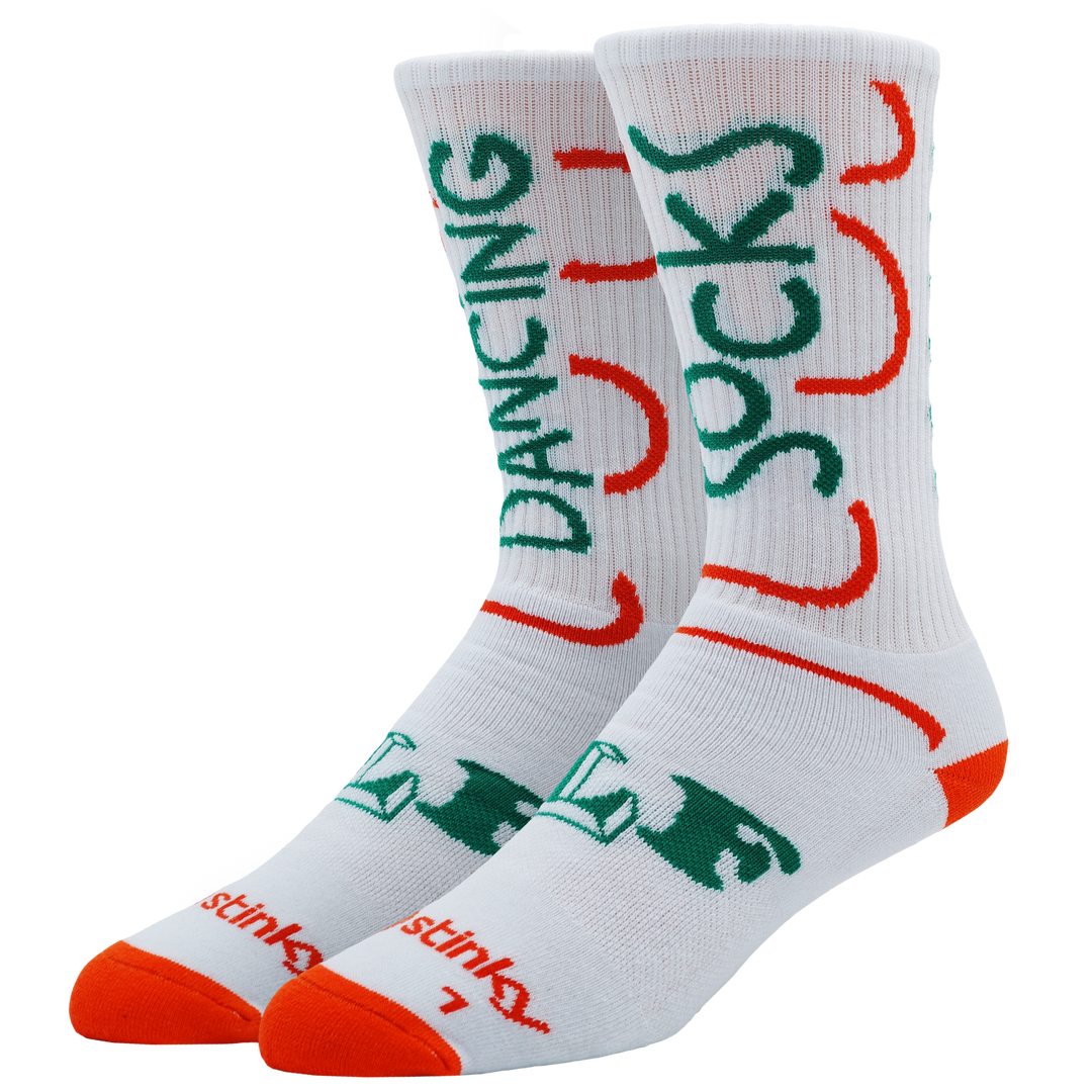 A pair of white crew socks with green and orange graphic text and lettering, displayed against a plain white background. Text sais Dancing Socks