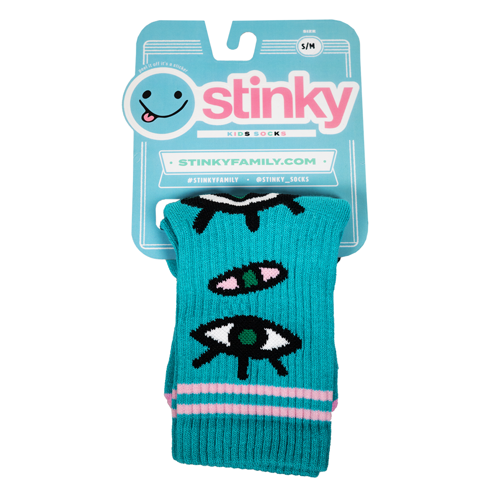 Teal dog toy with eye designs in packaging featuring the brand 'Stinky'.